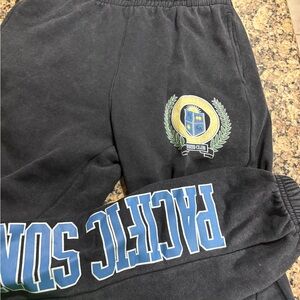 Pacific Sunwear Black Joggers men’s small  with Blue and Yellow Crest